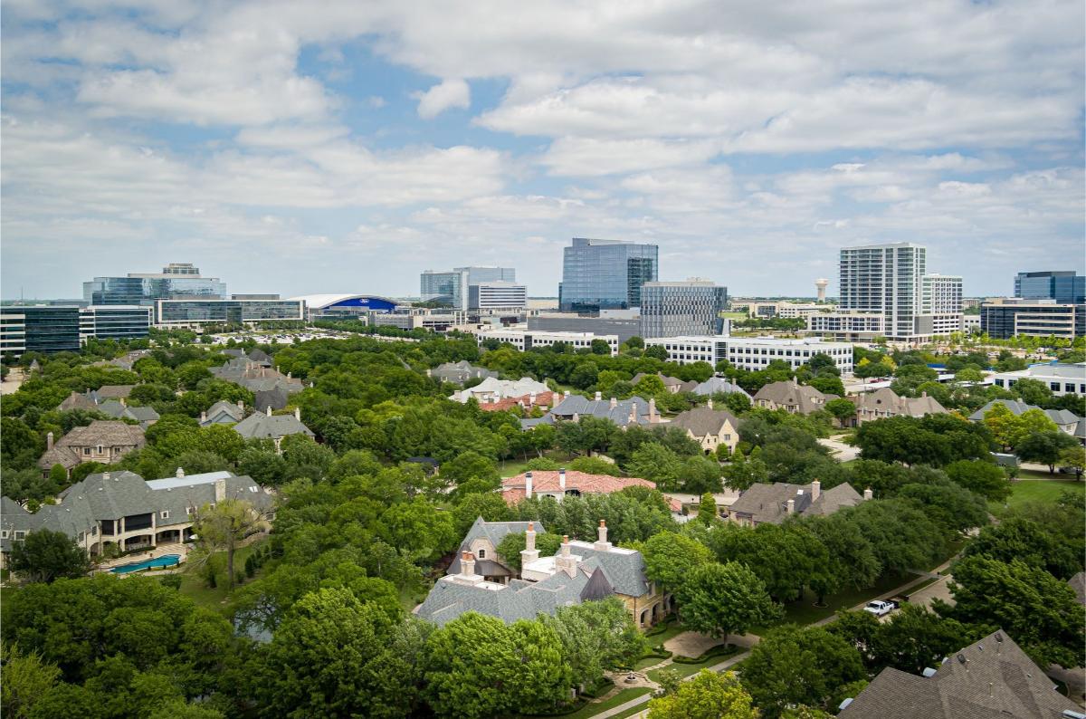 Aerial view of the mansion with the city in the background.