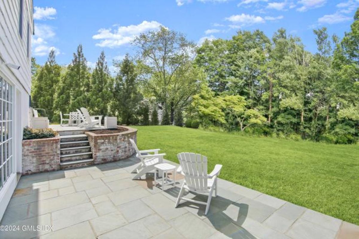 A patio furnished with chairs and a coffee table.
