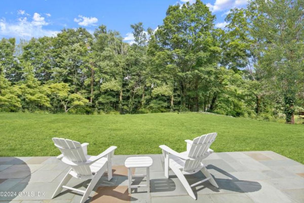 A patio furnished with chairs and a coffee table.
