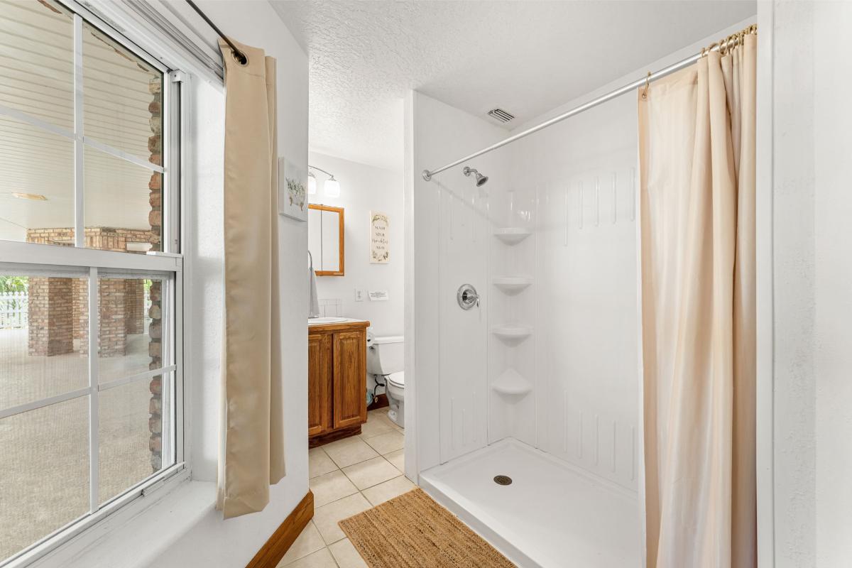 Bathroom with a sink, toilet and a shower.