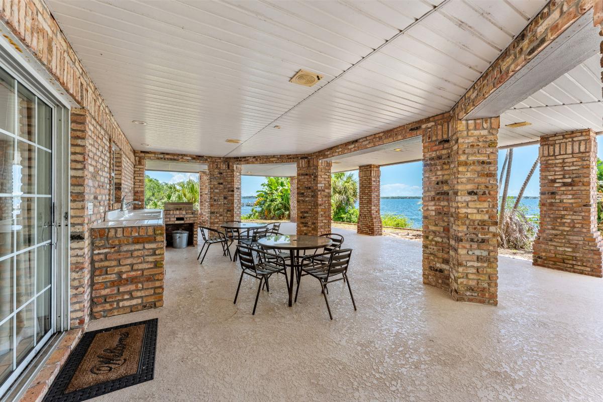 Covered patio with tables and chairs.