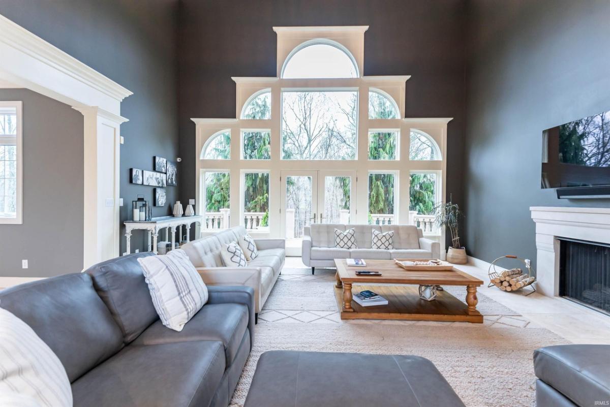 Living room with floor-to-ceiling windows and a fireplace.