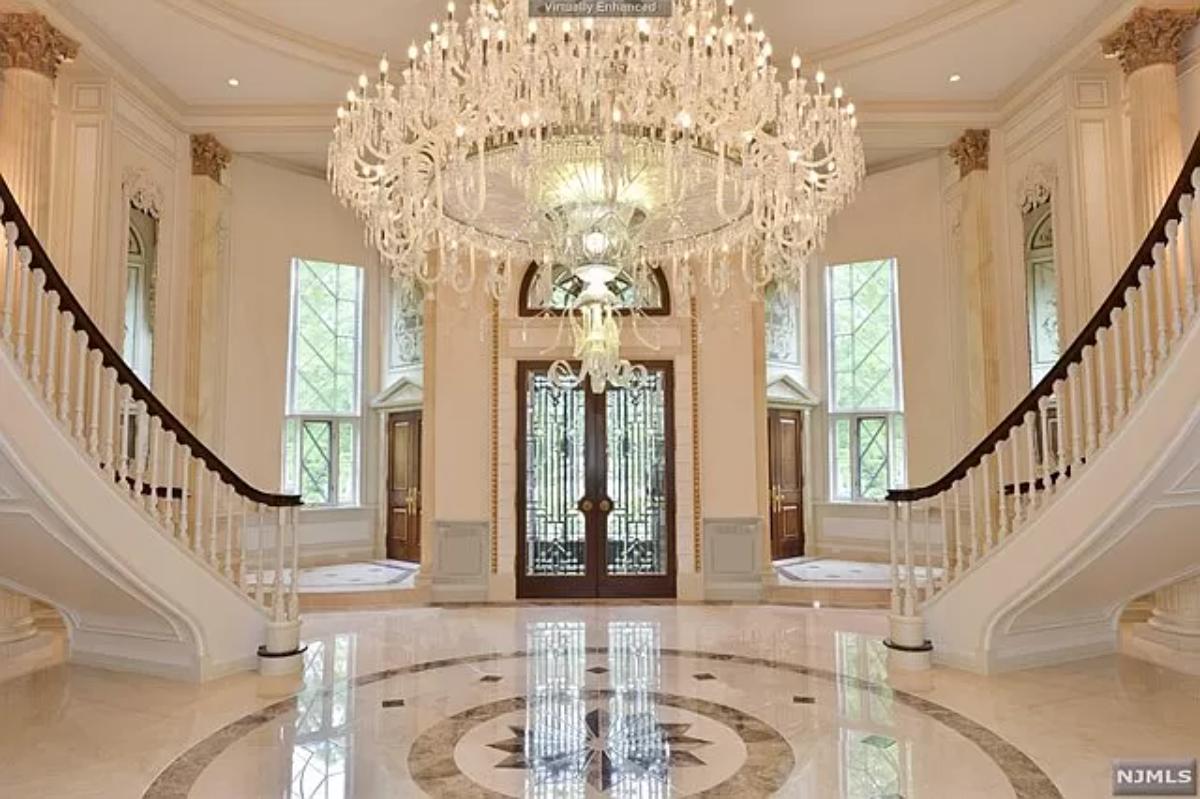 Foyer with a chandelier and stairs.