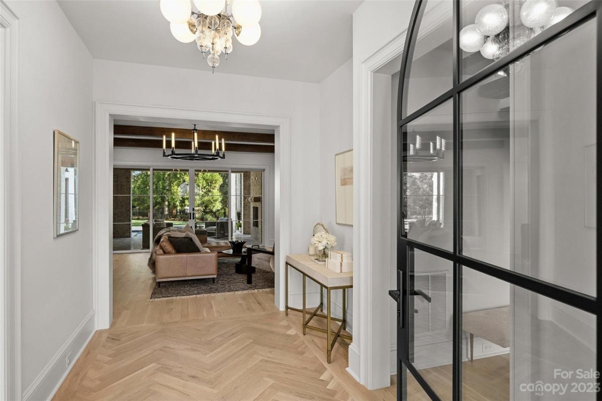 Foyer with a chandelier and glass door.