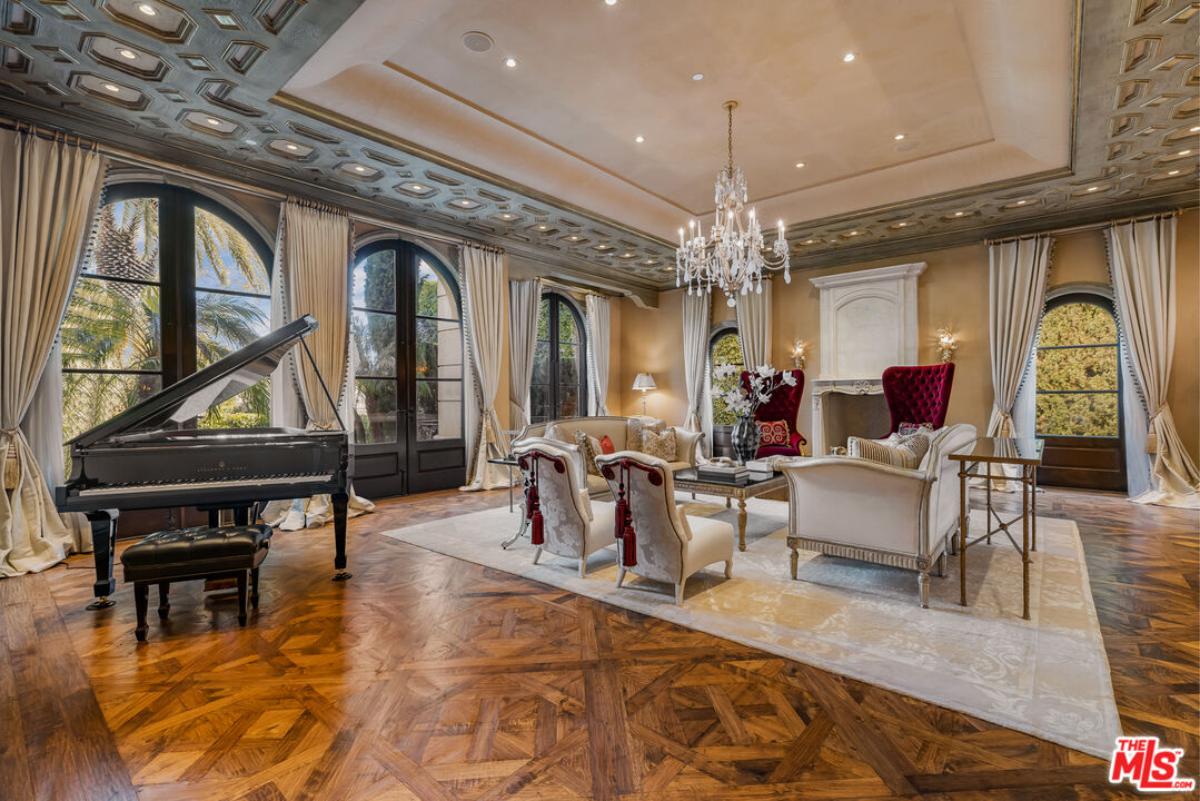 Living room with a chandelier and a piano.