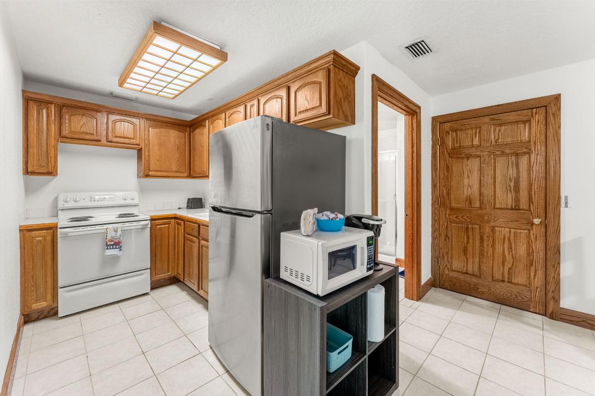 Kitchen with a gas burner, fridge, sink and cabinets.
