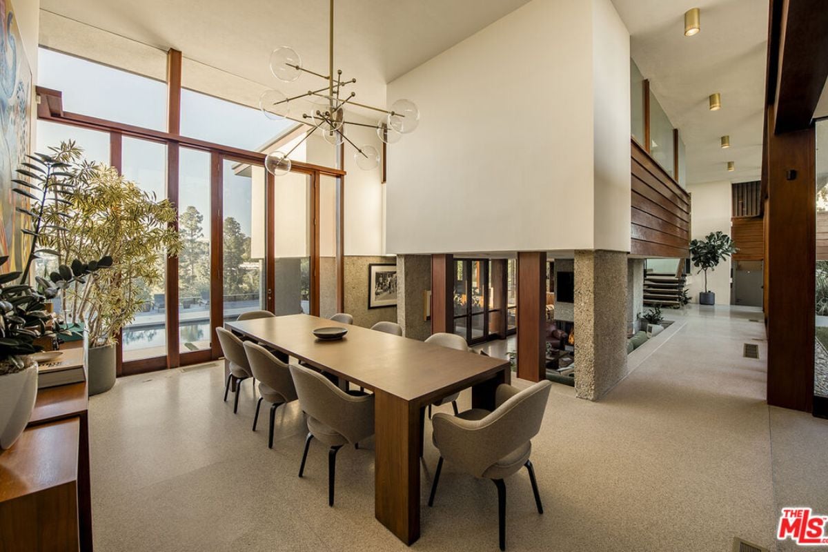 A dining room with a dining table surrounded by chairs.