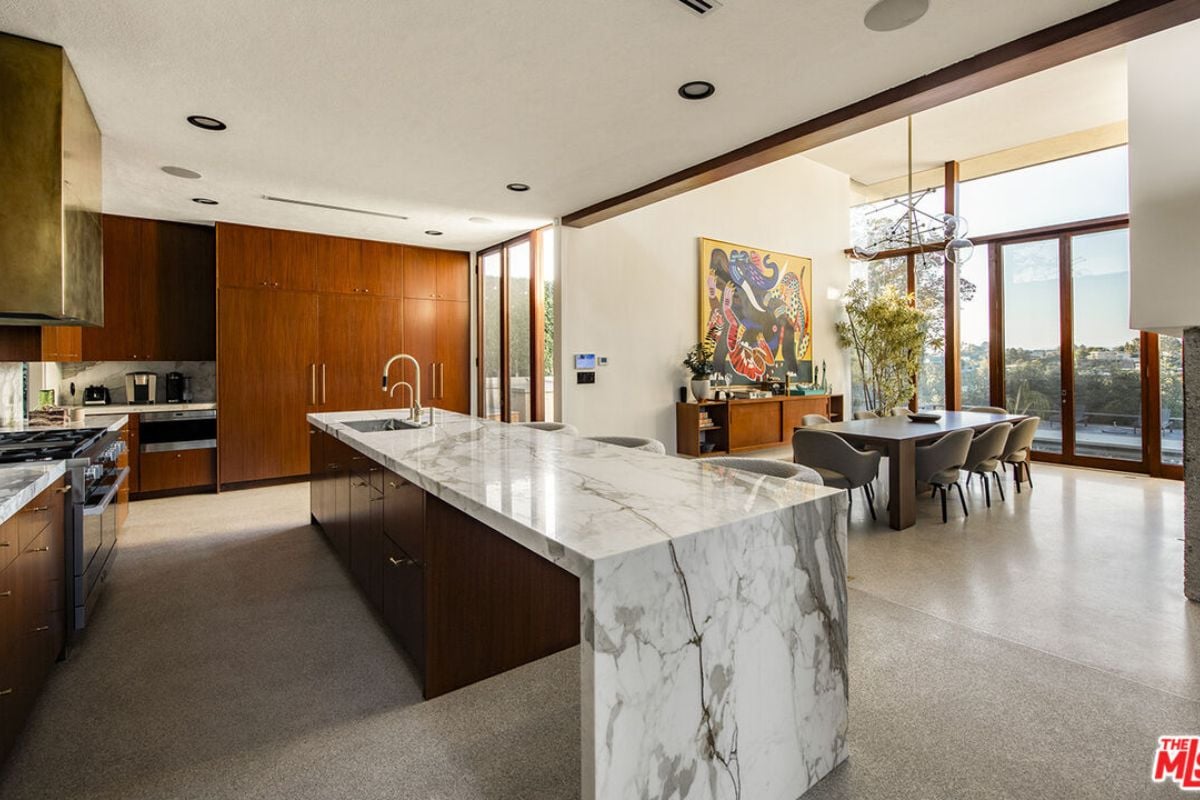A kitchen with countertops, sink, cabinets, and kitchen appliances.