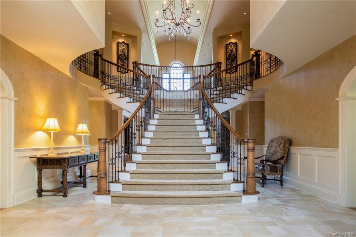 Foyer with a chandelier and stairs.