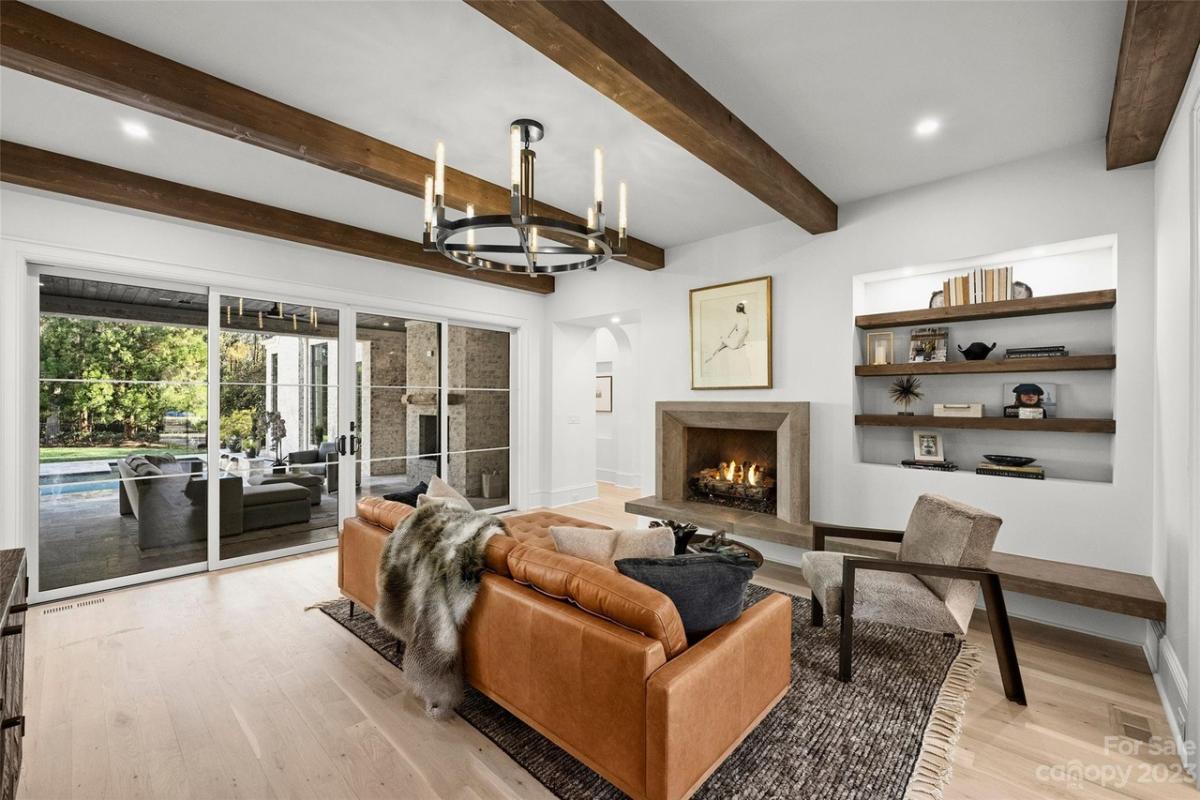 Living room with a fireplace and vaulted ceiling.