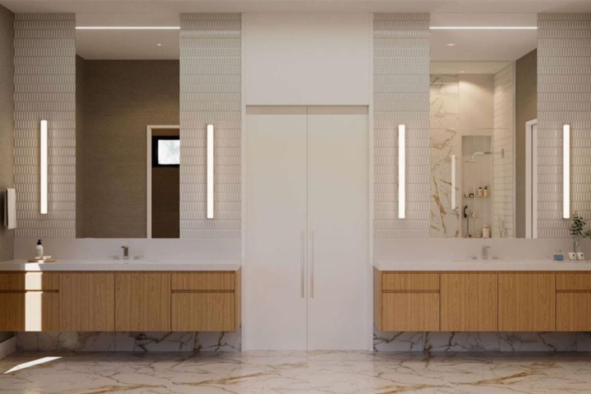 A bathroom with marble floors, countertops, sinks, and mirrors.