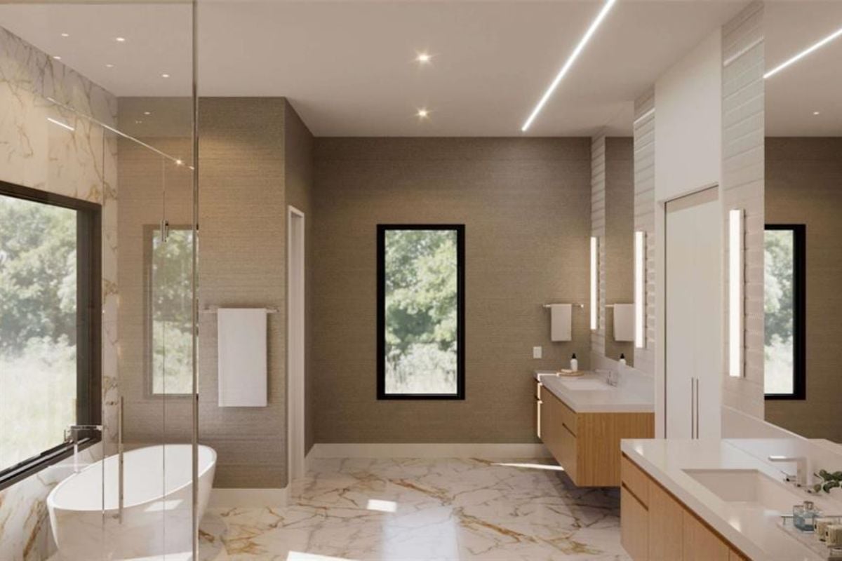 A bathroom with marble floors, countertops, sinks mirrors and bathtub.