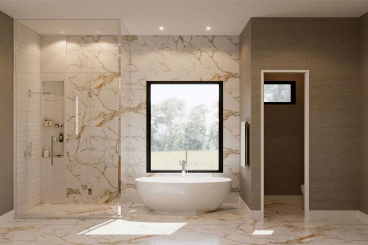 A bathroom with marble walls, marble floors, a bathtub, and a shower room.