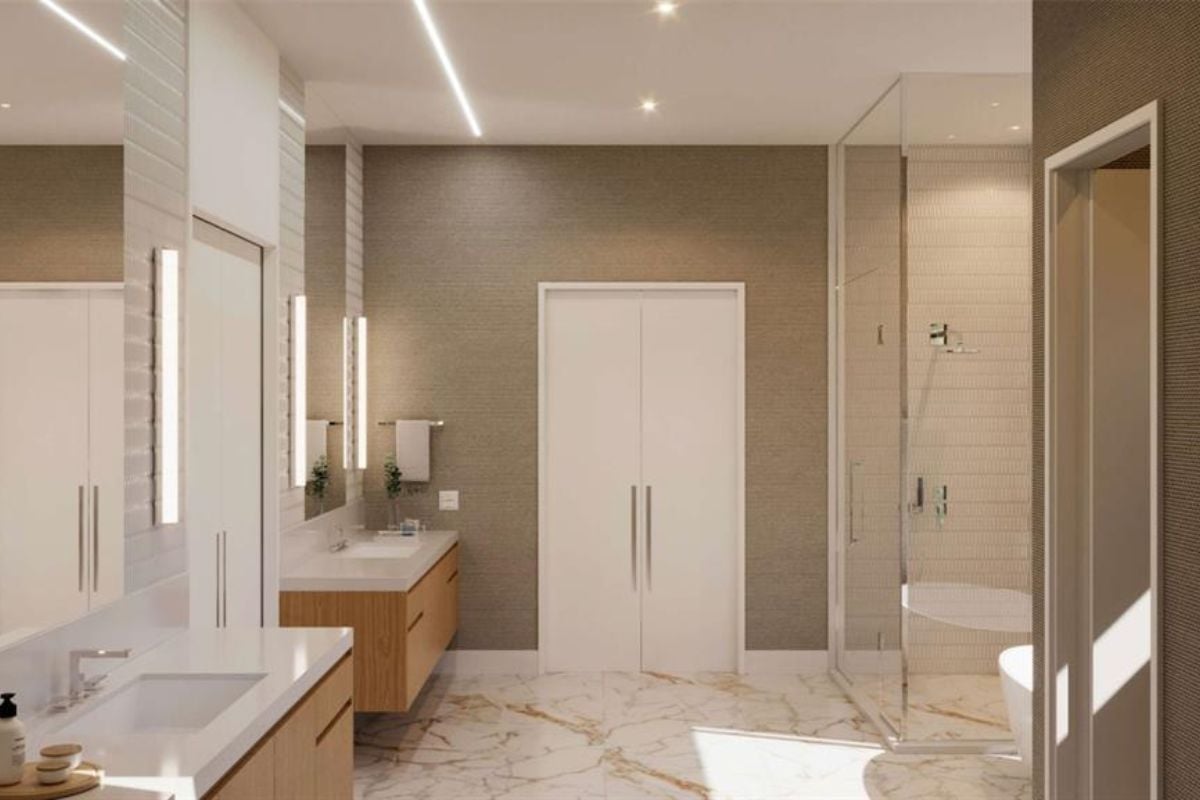 A bathroom with vanities, mirrors, cabinets, and a marble floor.
