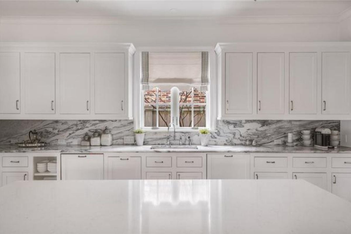 A kitchen with an island, countertop, and cabinets.
