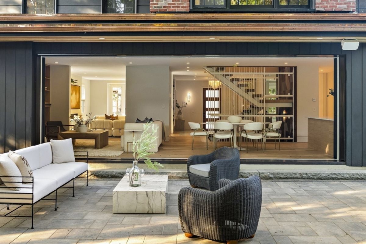 A patio with a couch, chairs, and a center table.