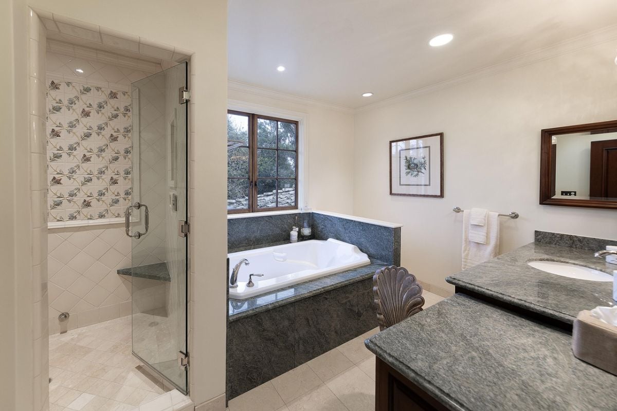 A bathroom with a vanity, bathtub, and shower.