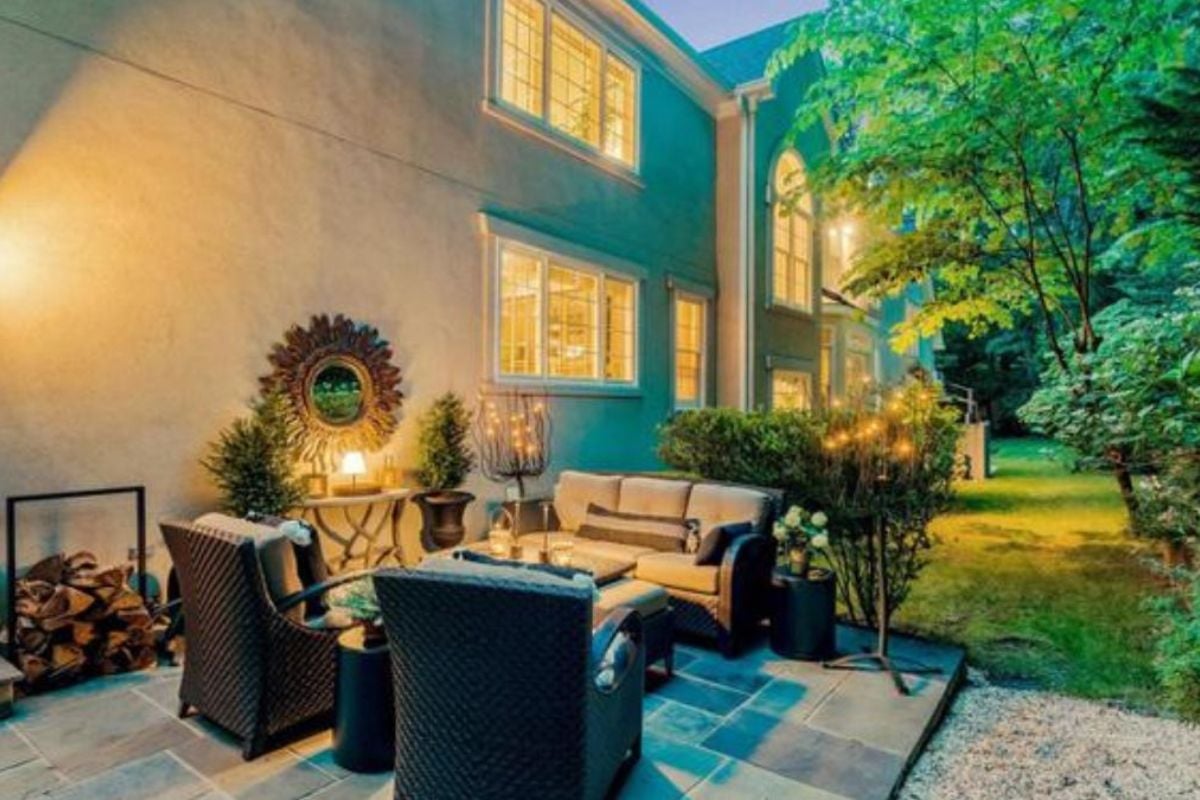 A patio with a chair, couch, and center table.