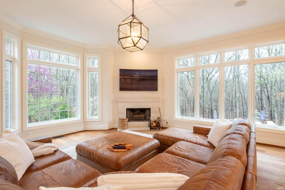 Living room with couches and a fireplace.