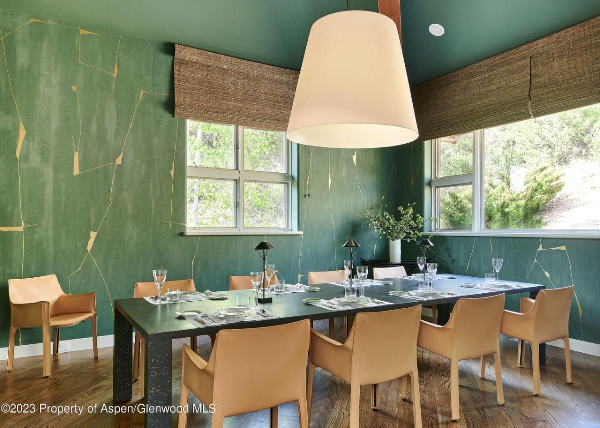 Dining room with hardwood floor and glass windows.