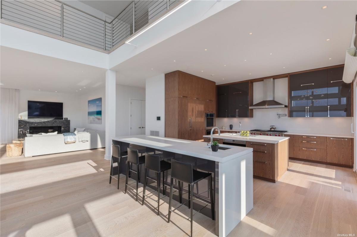 Kitchen with a spacious counter breakfast bar, custom cabinetry and center island prep area.