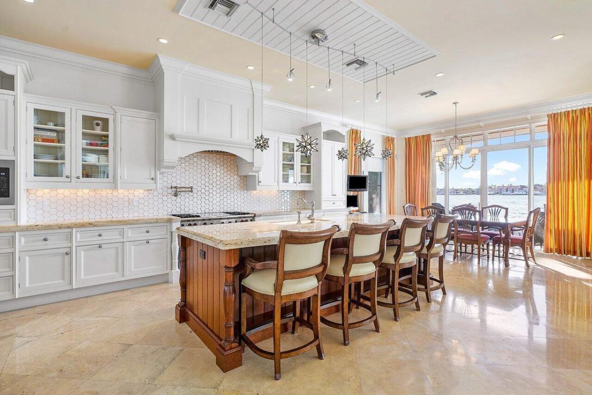 Kitchen with stainless steel appliances, a gas range, a spacious granite counter breakfast bar and center island prep area.
