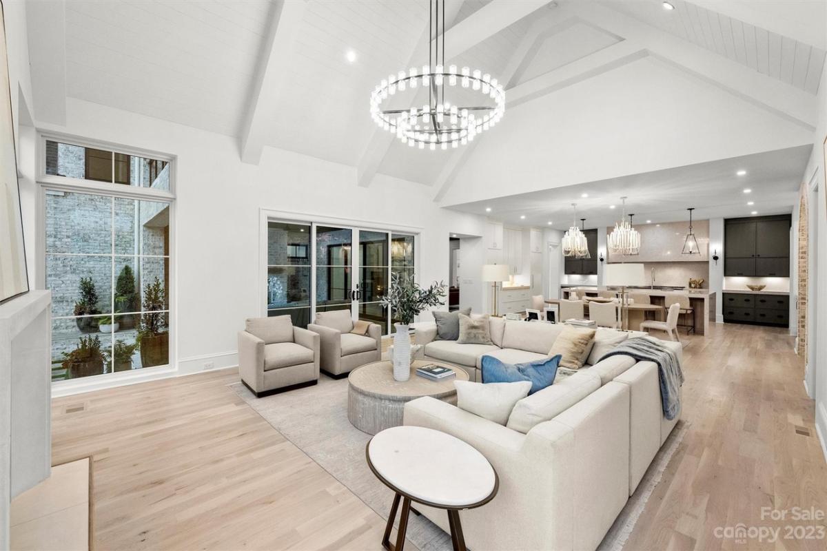 Living room with a chandelier and hardwood floors.