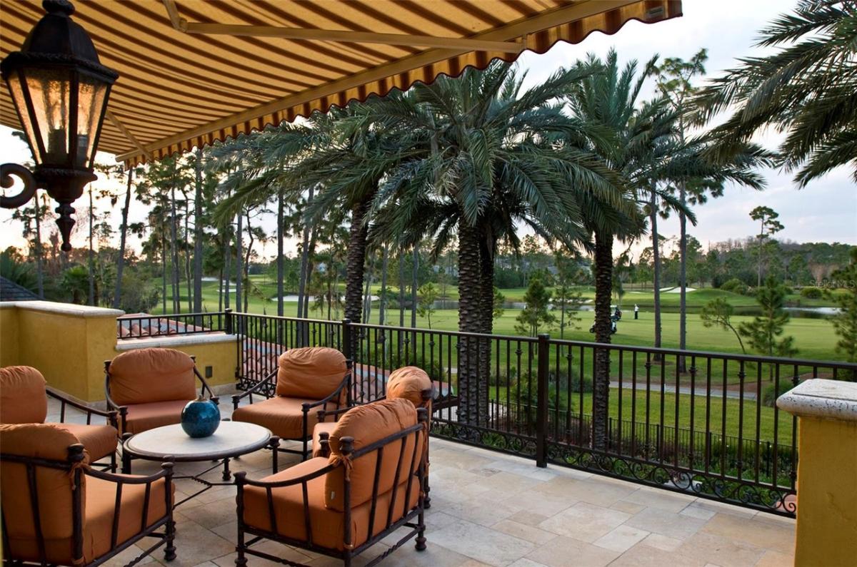 Balcony with a table and chairs.