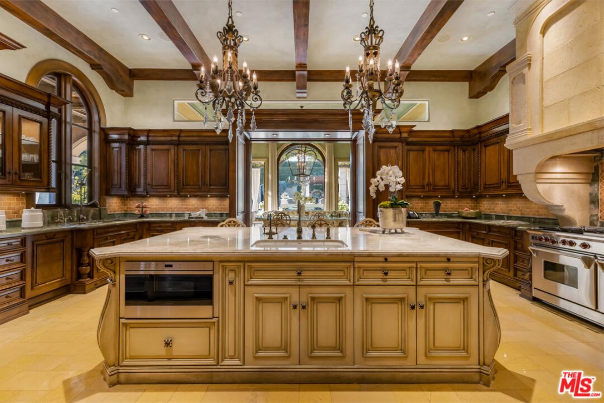 Kitchen with chandeliers and custom-made cabinetry.