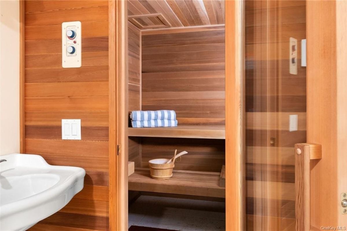 A bathroom with a vanity and wooden cabinet.