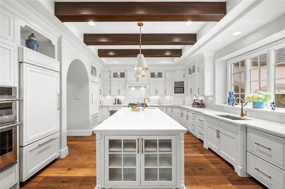 Kitchen with vaulted ceiling, center island prep area and custom cabinetry.