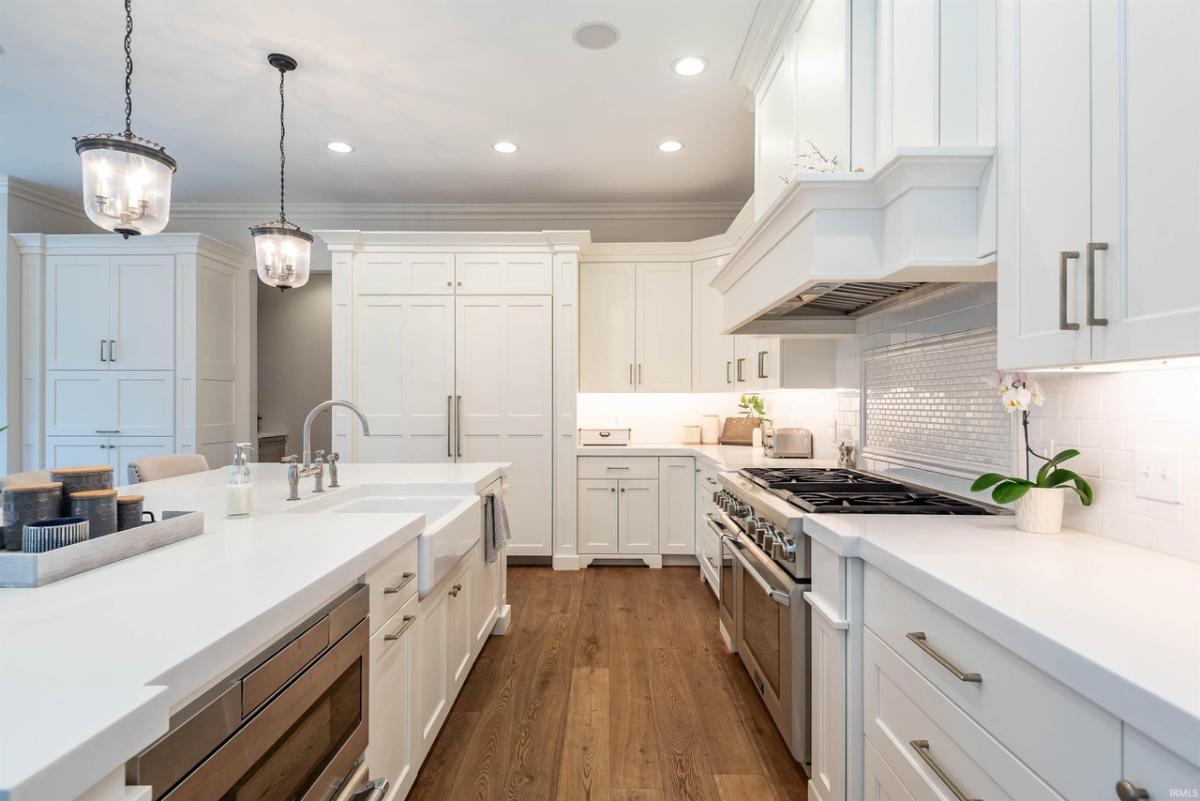 Kitchen with quartz countertops, breakfast bar and custom cabinetry.
