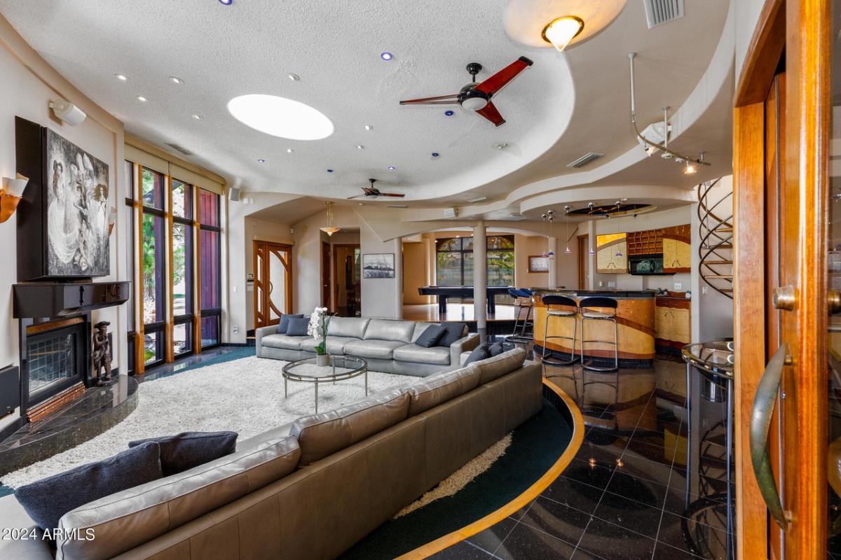 Entertainment room with couches, a fireplace and a bar.