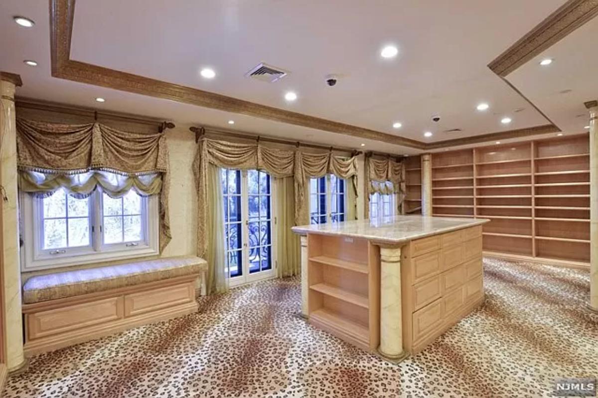 Walk-in closet with shelves and custom lighting.