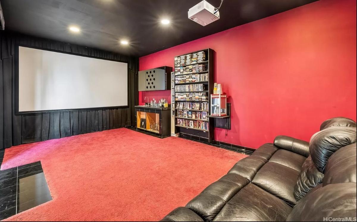 Home theater with carpet flooring and theater seats.