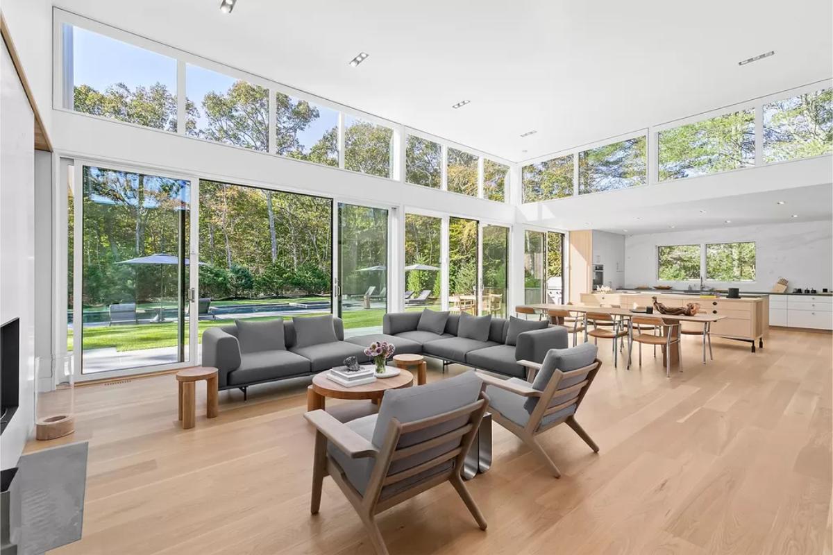 Living room with custom floor-to-ceiling windows and hardwood floor.