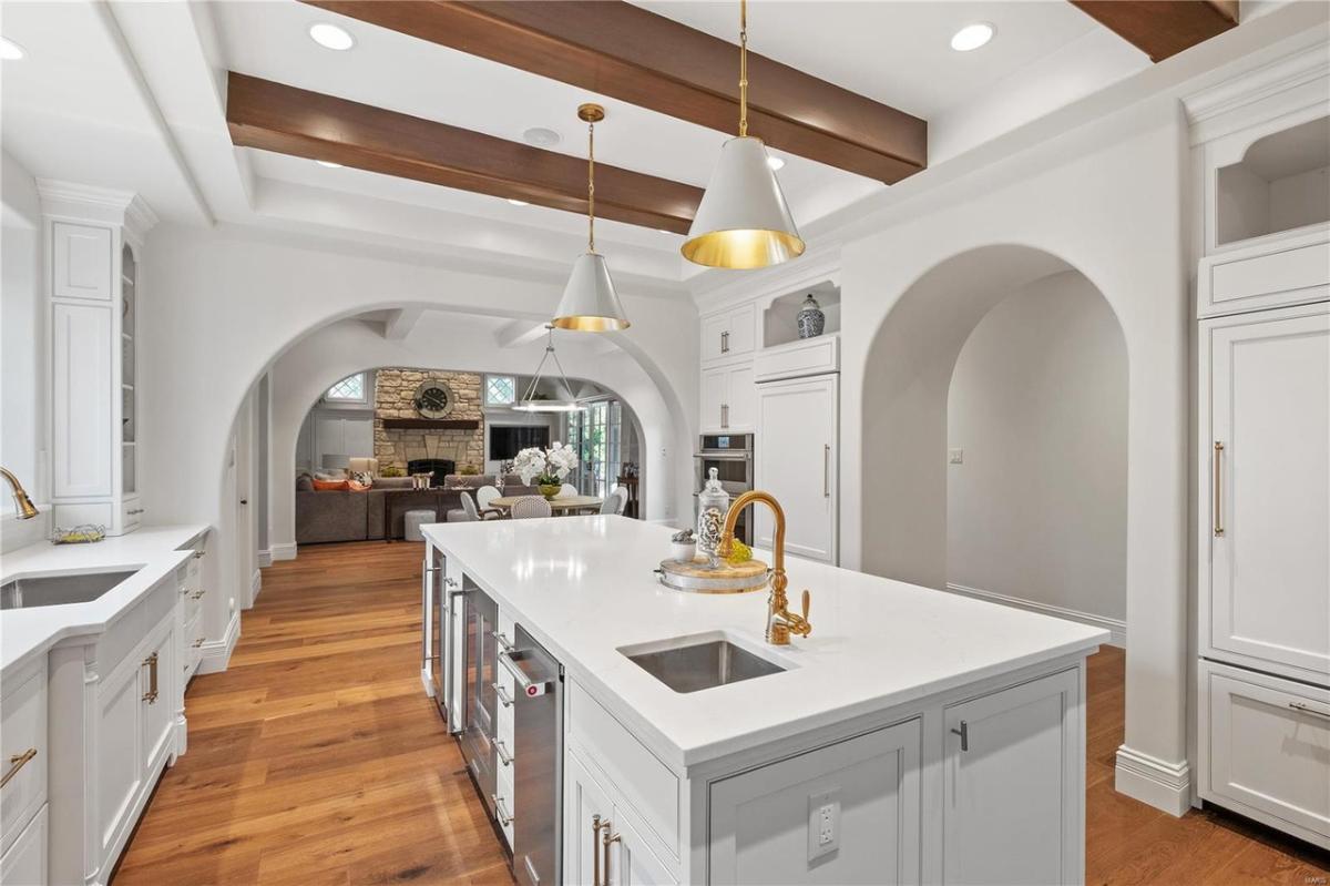 Kitchen with vaulted ceiling, center island prep area and custom cabinetry.
