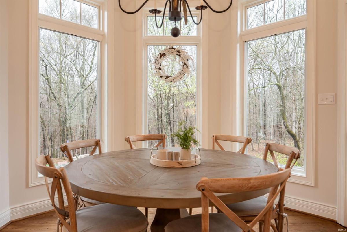 Breakfast nook with a round wood table and chairs.