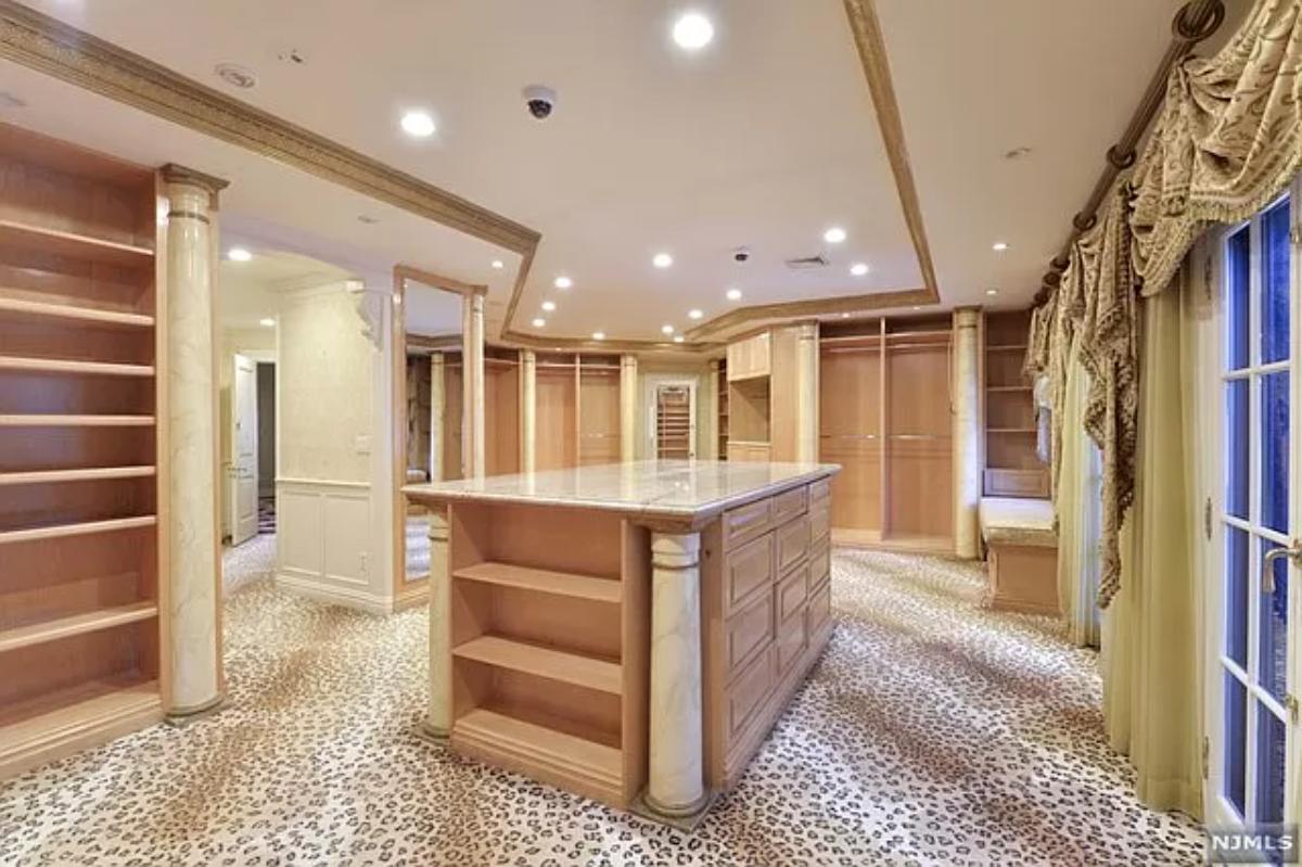 Walk-in closet with shelves and custom lighting.