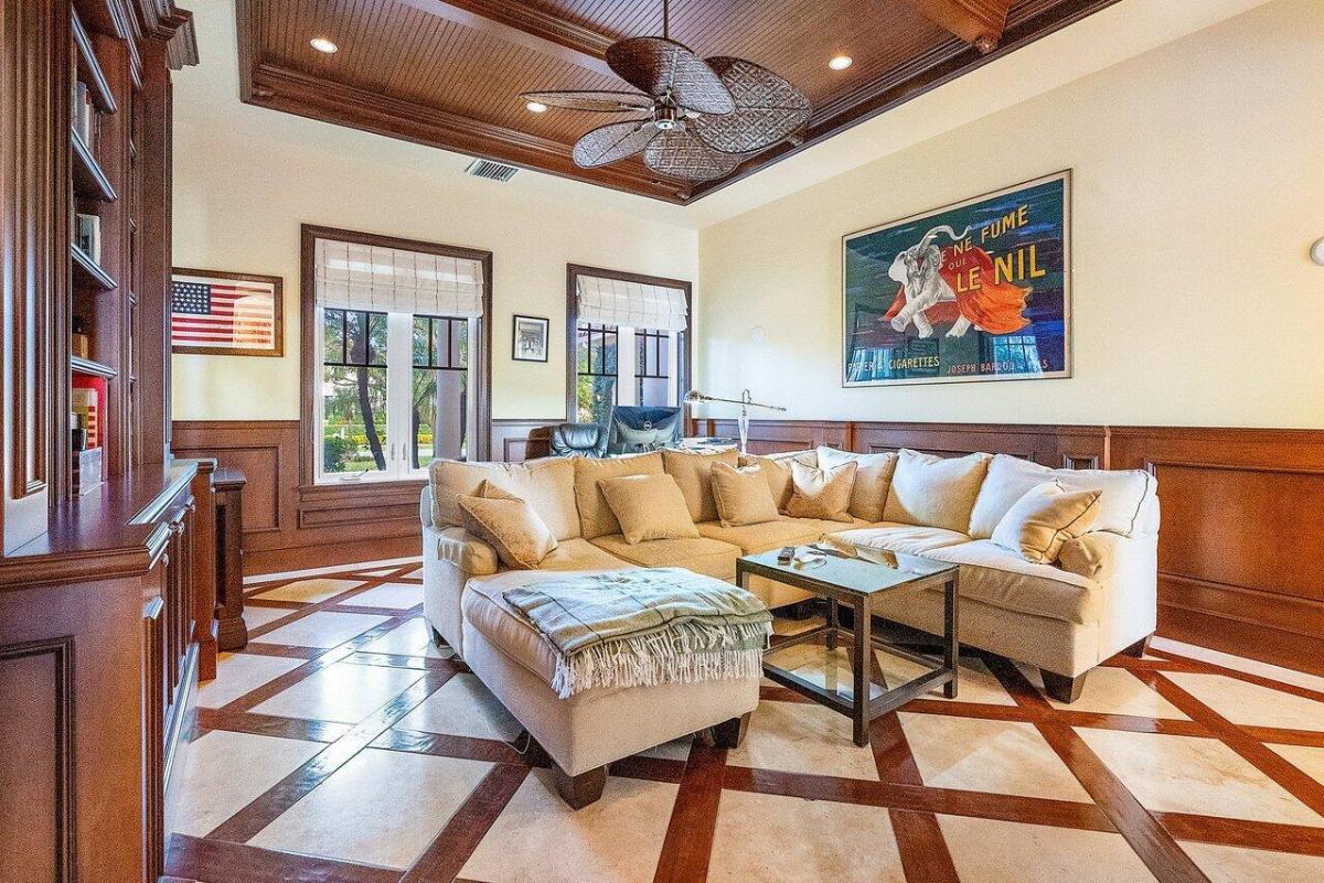 Sitting area with coffered ceiling and couches.