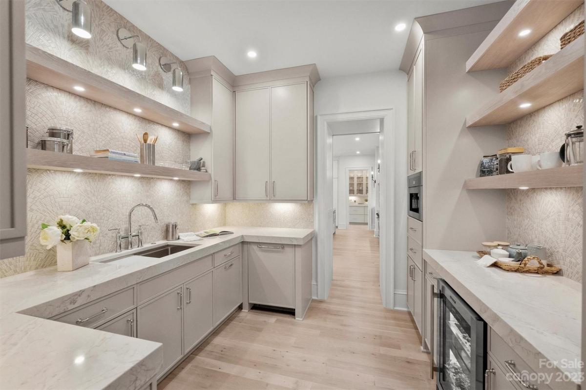 Pantry with custom lighting and custom cabinetry.