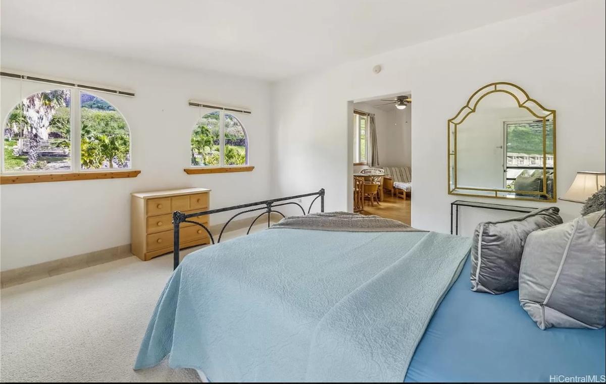 Bedroom with carpet flooring and glass windows.