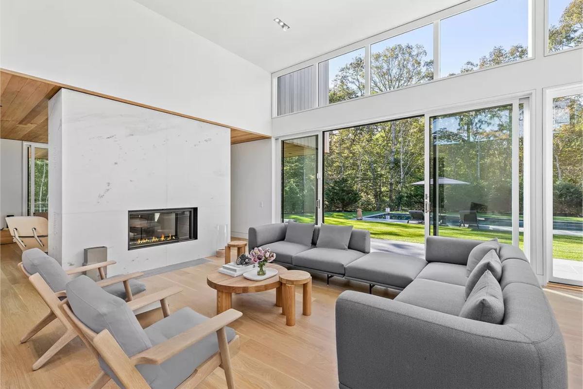 Living room with custom floor-to-ceiling windows and hardwood floor.