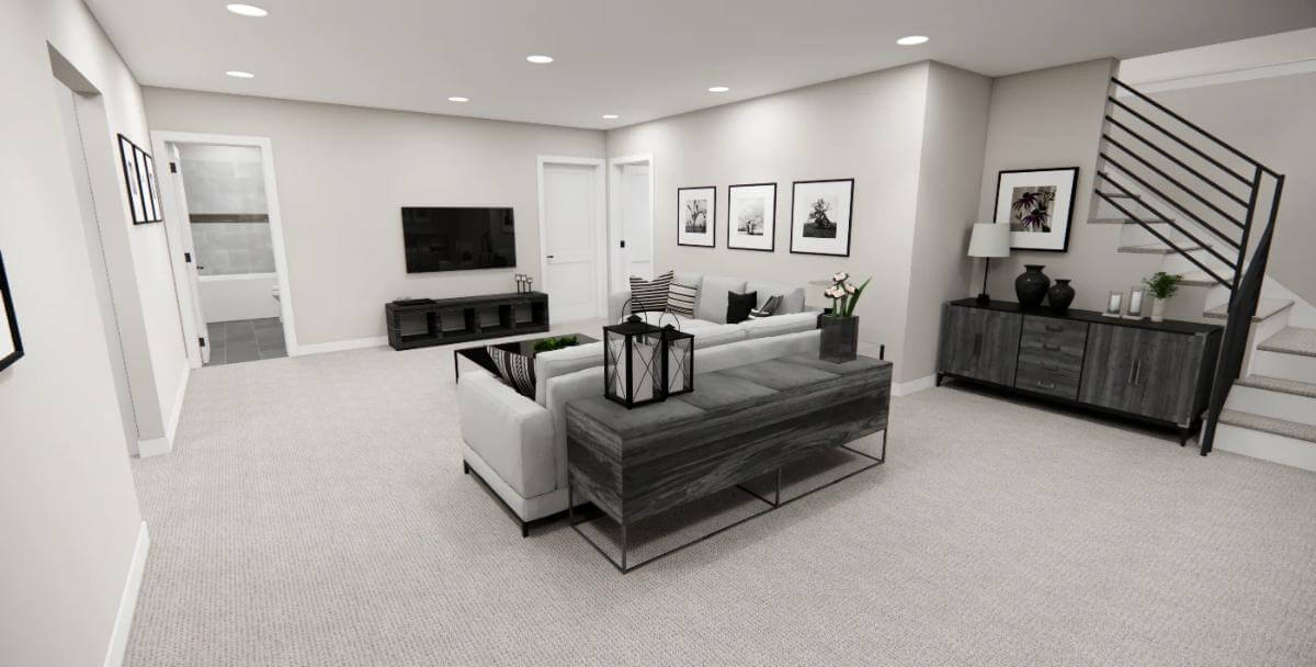 Living room with a gray sofa, a wall-mounted TV, and white walls adorned by black-framed windows.