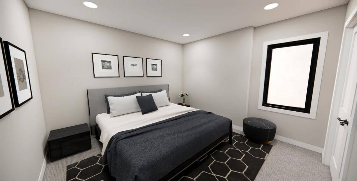 Bedroom with an upholstered bed over the patterned area rug.