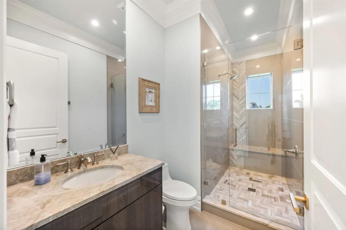 Bathroom with a sink, toilet and a walk-in shower.