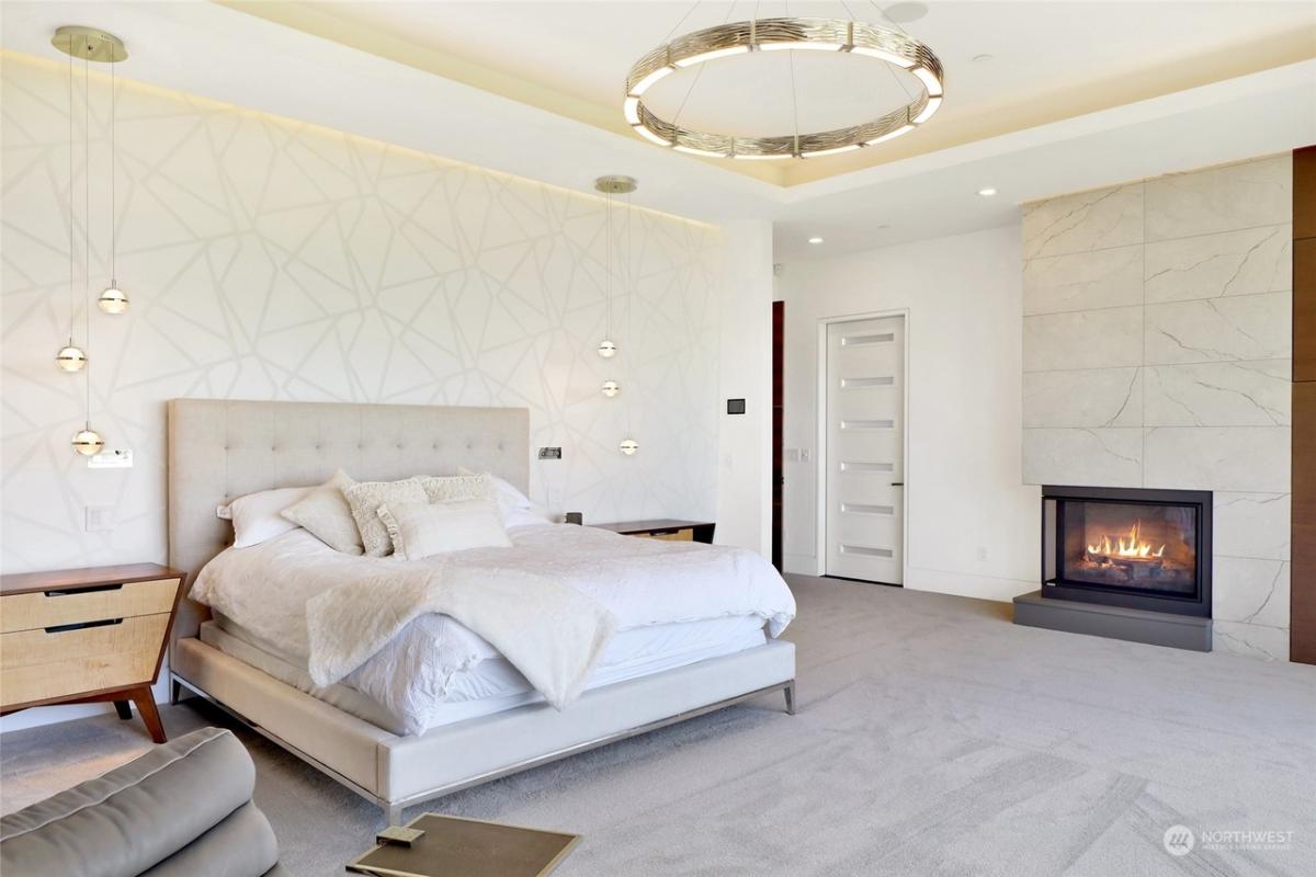 Bedroom with carpet flooring and a fireplace.