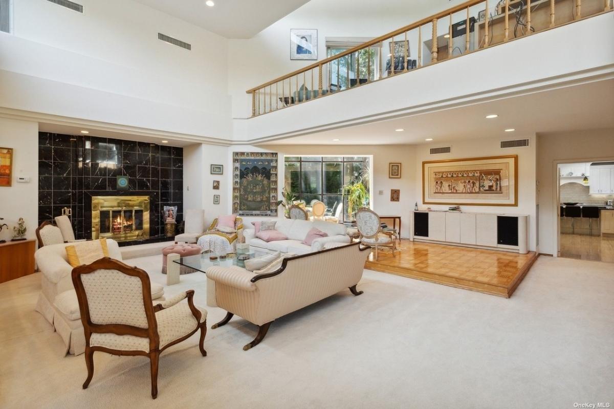 Living room with couches and a fireplace.