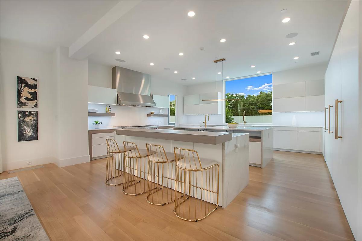 Kitchen with counter breakfast bar and a center island prep area.
