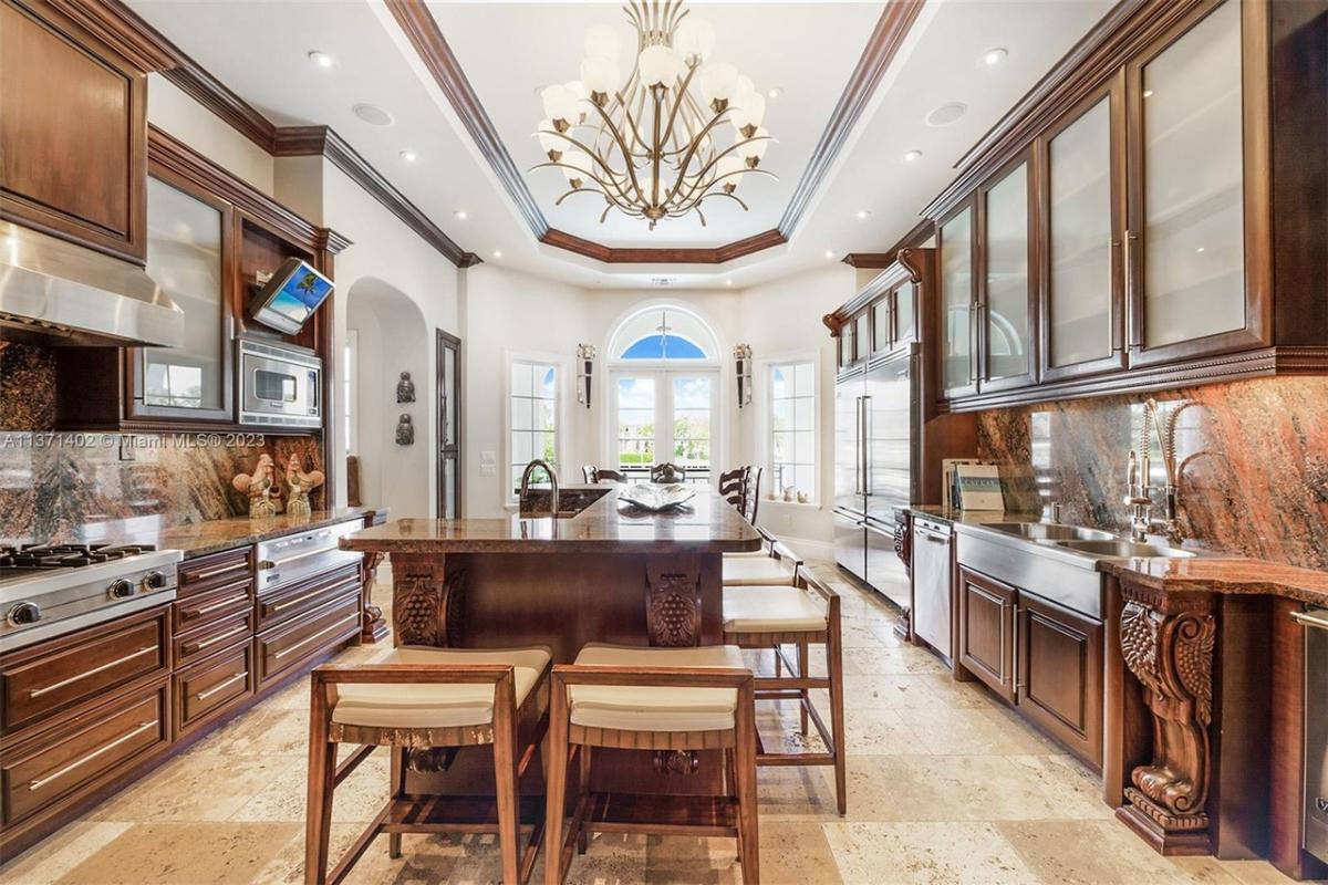 Kitchen with stainless-steel appliances and a counter breakfast bar.
